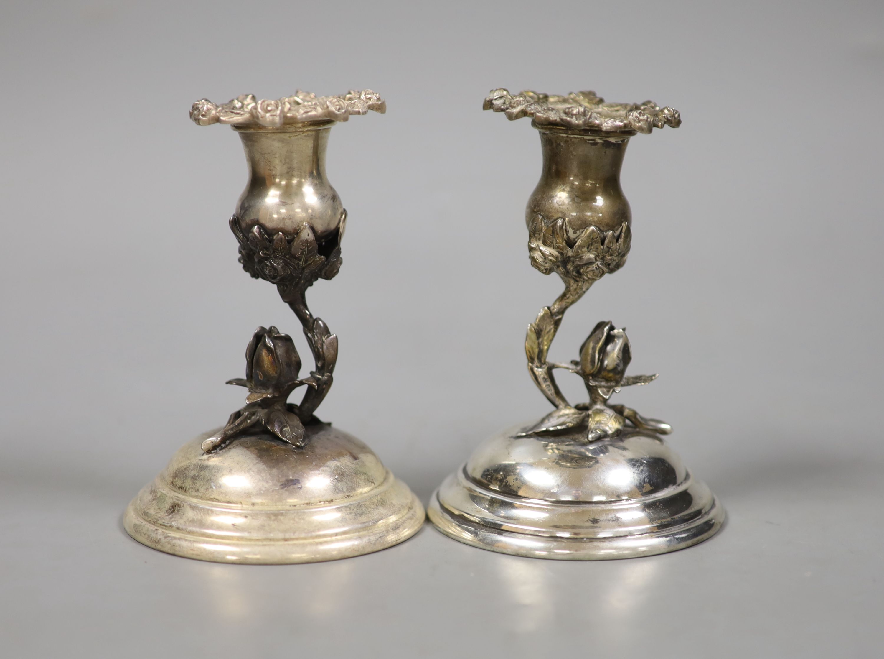 A pair of continental 830 white metal dwarf candlesticks, with foliate stems, height 12.3cm
